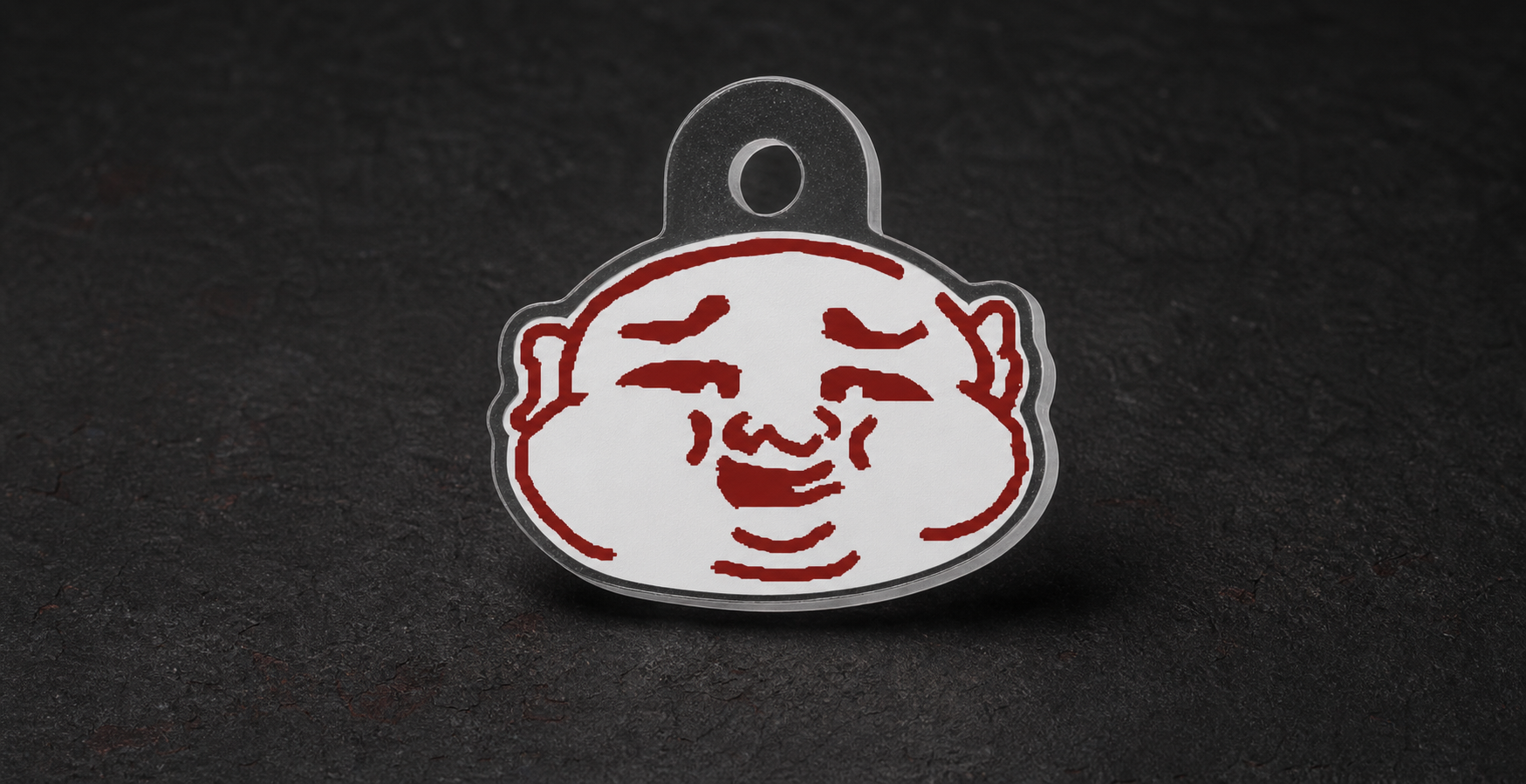 CHUBB face character keychain on a charcoal studio background